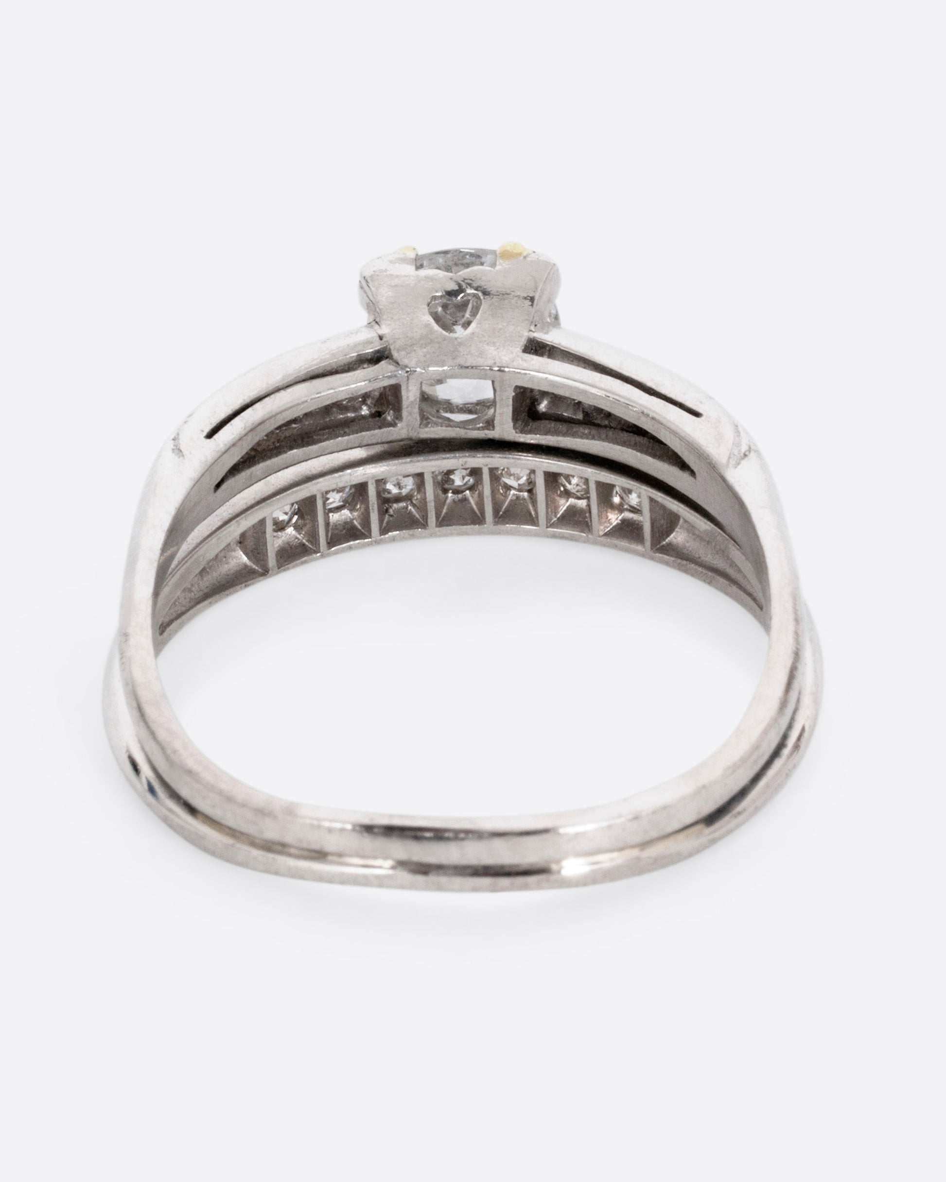 A platinum ring with an Old European cut diamond and a split shank, shown from the back.
