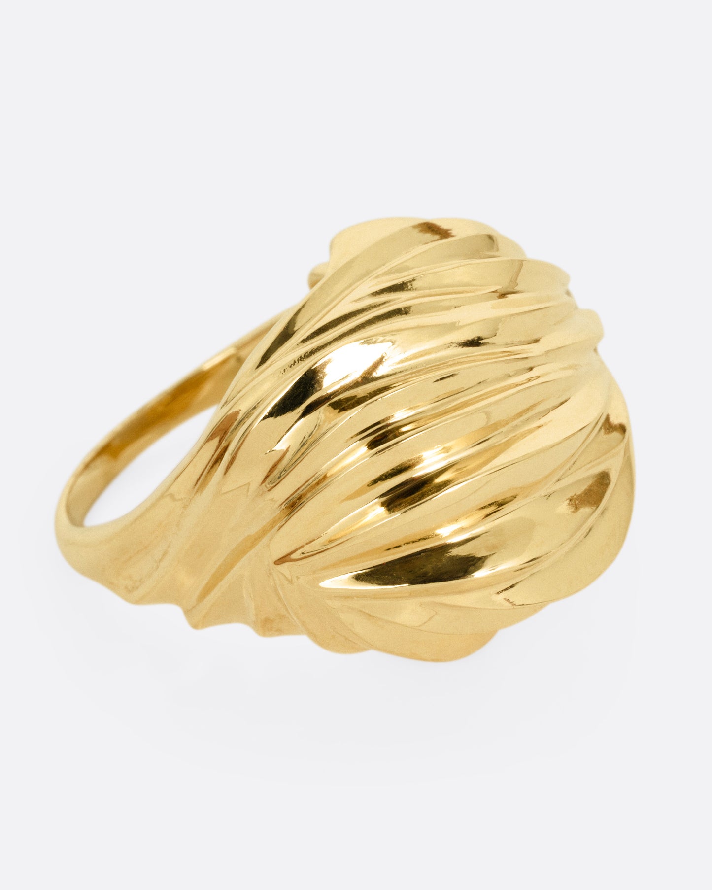 A yellow gold textural dome ring with a rose cut diamond, shown from the side.