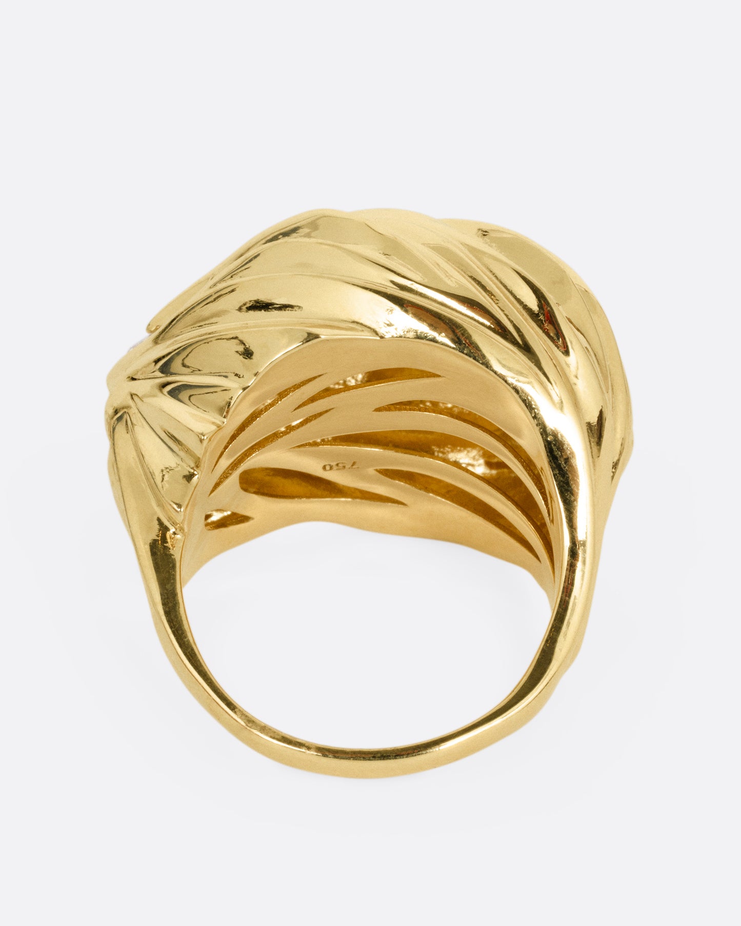A yellow gold textural dome ring with a rose cut diamond, shown from the back.