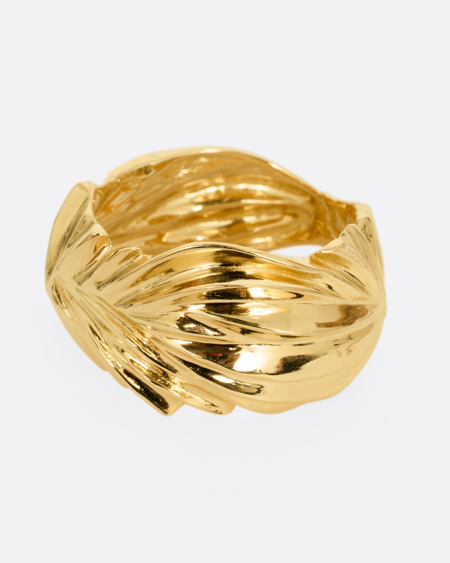 A yellow gold ring with wavy and chevron textures, shown from the front.