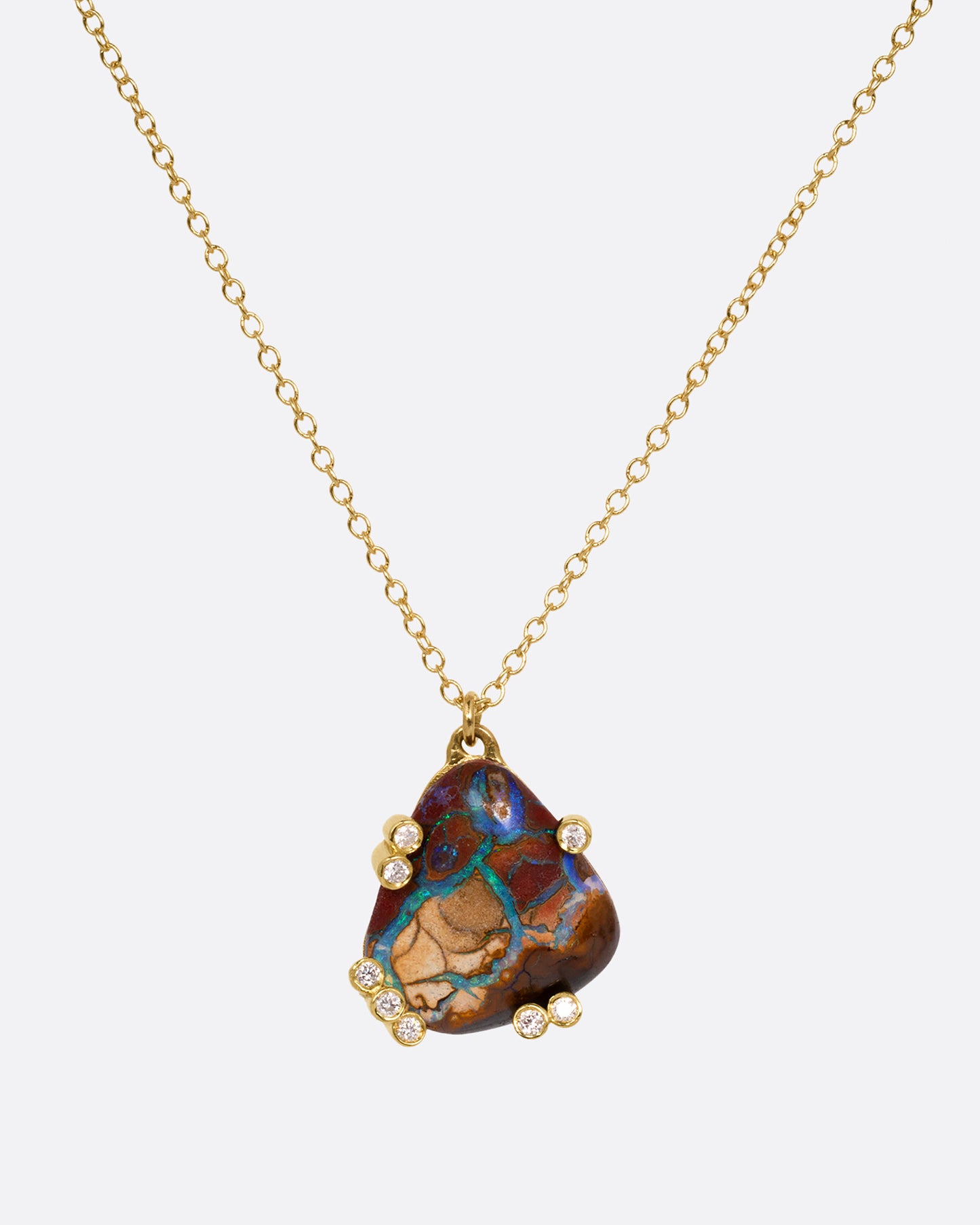 A yellow gold cable chain necklace with a free-form boulder opal and diamond anemones. Shown from the front.