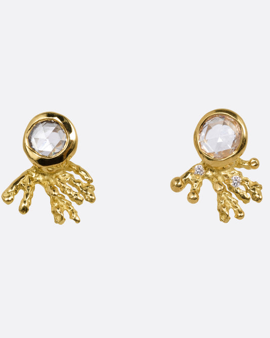 A pair of yellow gold studs earrings with rose cut diamonds and yellow gold comet-like tails. Shown from the front.