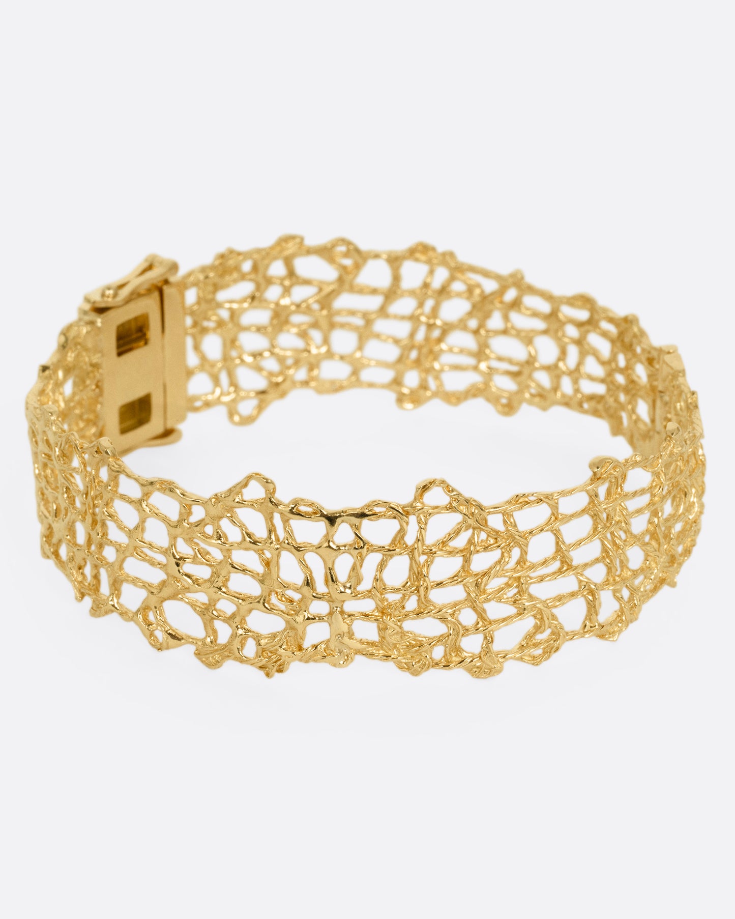 A woven yellow gold wire strand bracelet shown from the side.