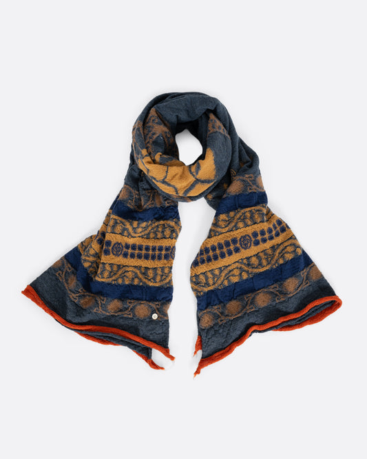 A navy blue and grey scarf with a golden yellow skull in the center. Shown loosely tied. 