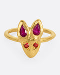 A yellow gold ring with a fox face with ruby tipped ears and orange sapphire eyes, shown from the front.