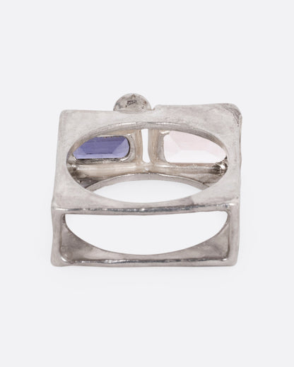 A silver square cage ring with a quartz, iolite, and topaz, shown from the back.
