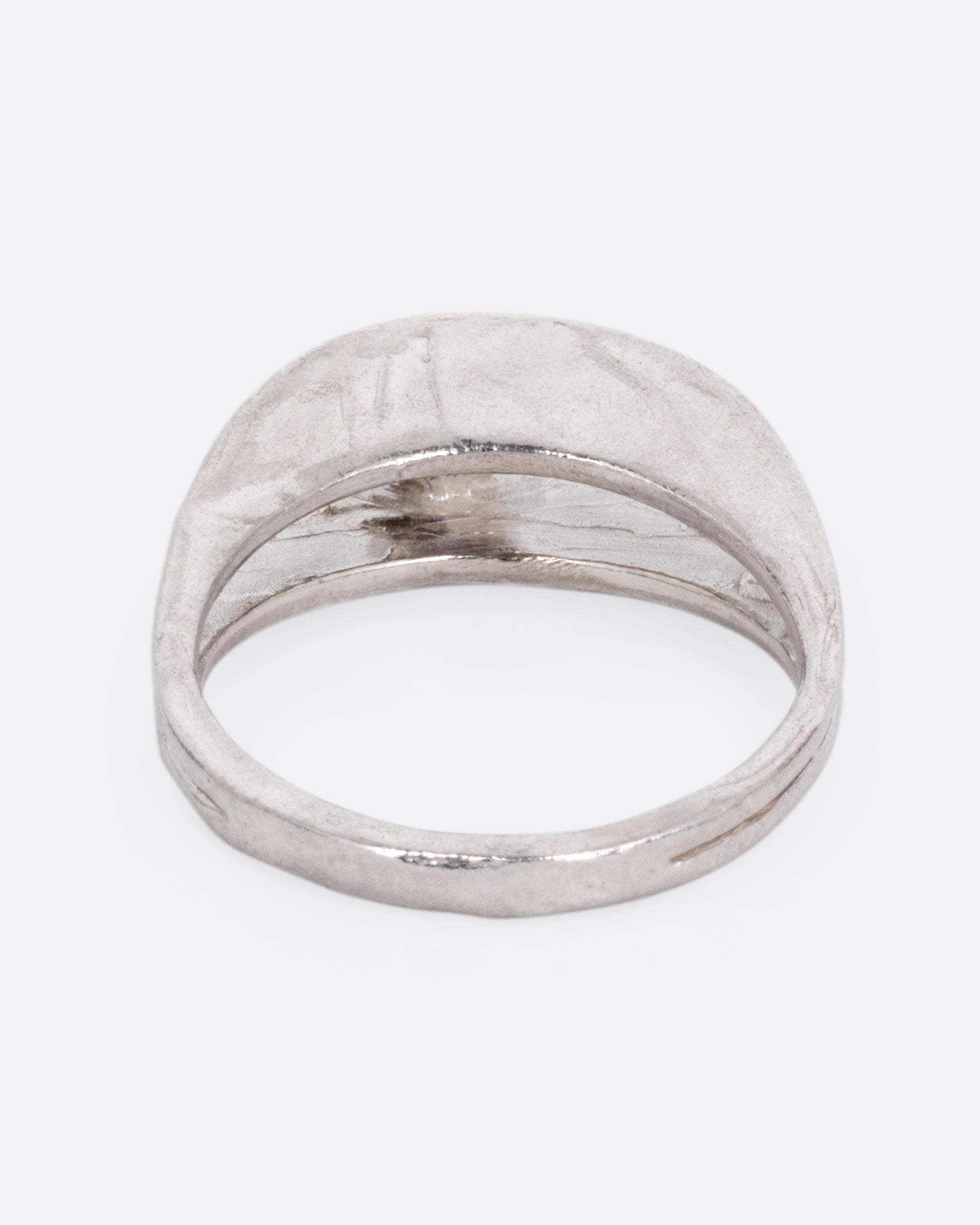 A silver ring with a split shank and a center iolite, shown from the back.