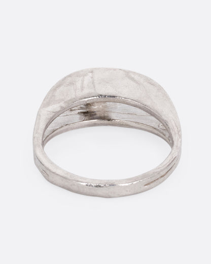 A silver ring with a split shank and a center iolite, shown from the back.