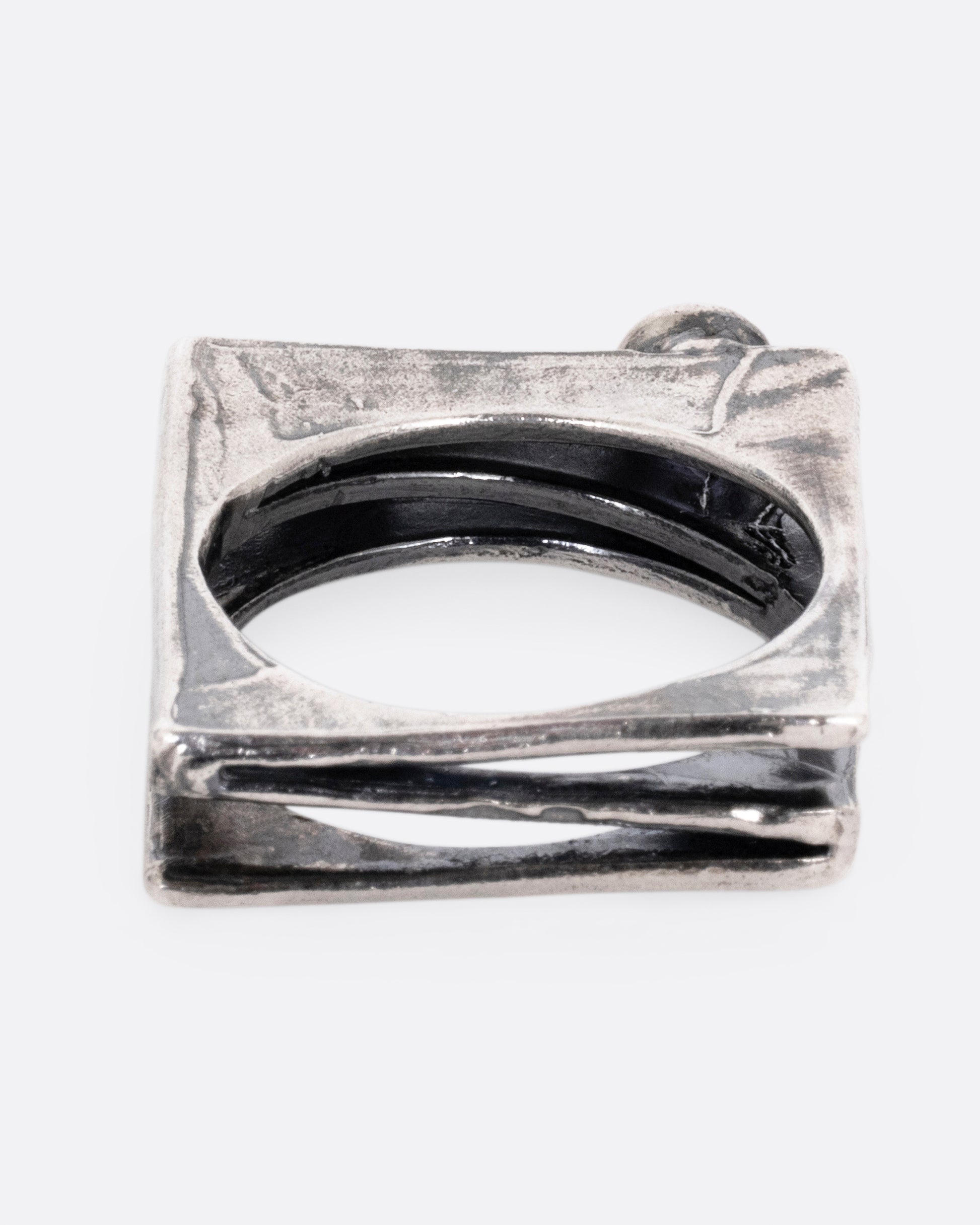 A silver stacked square ring with a blue sapphire and a pink sapphire shown from the back.