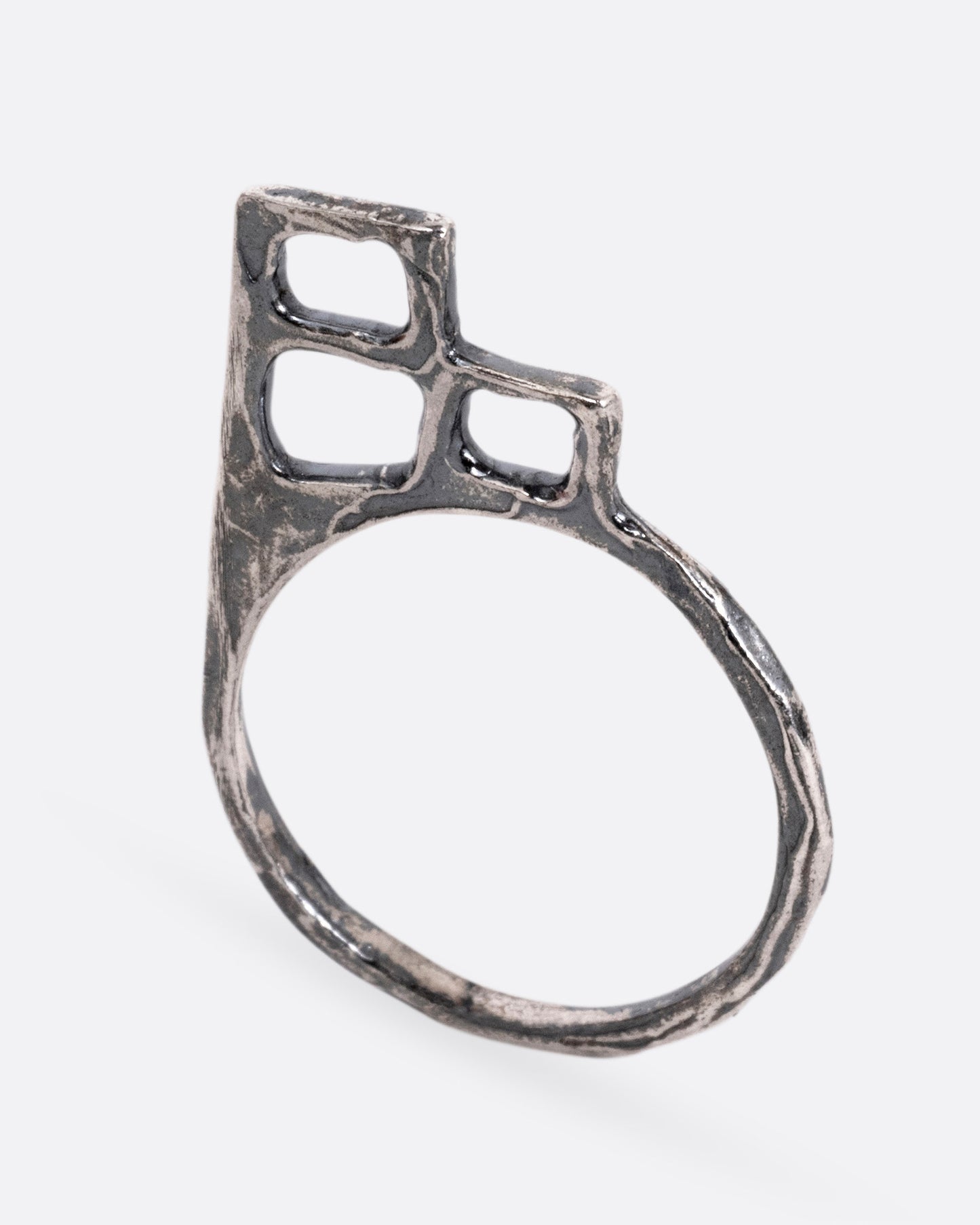 A silver ring with trio of stacked open windows, shown standing up from the front.