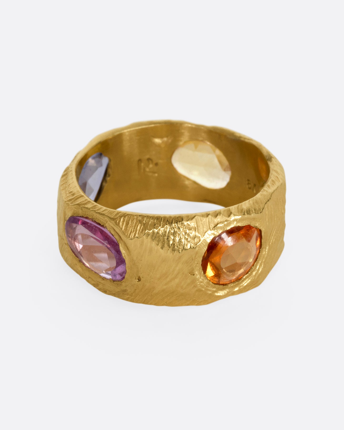 A yellow gold band with rose cut multicolor sapphires all the way around.