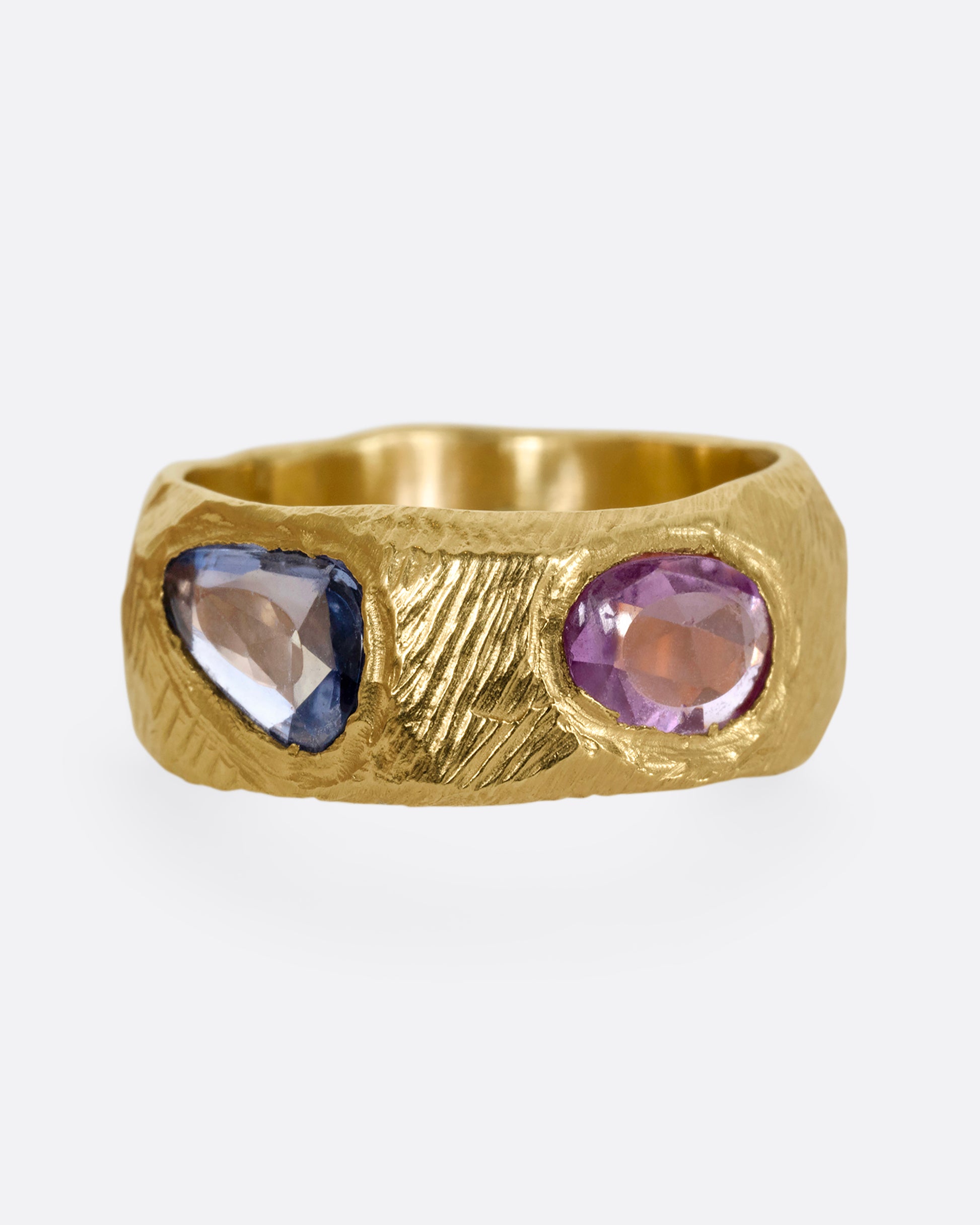 A yellow gold band with rose cut multicolor sapphires all the way around.