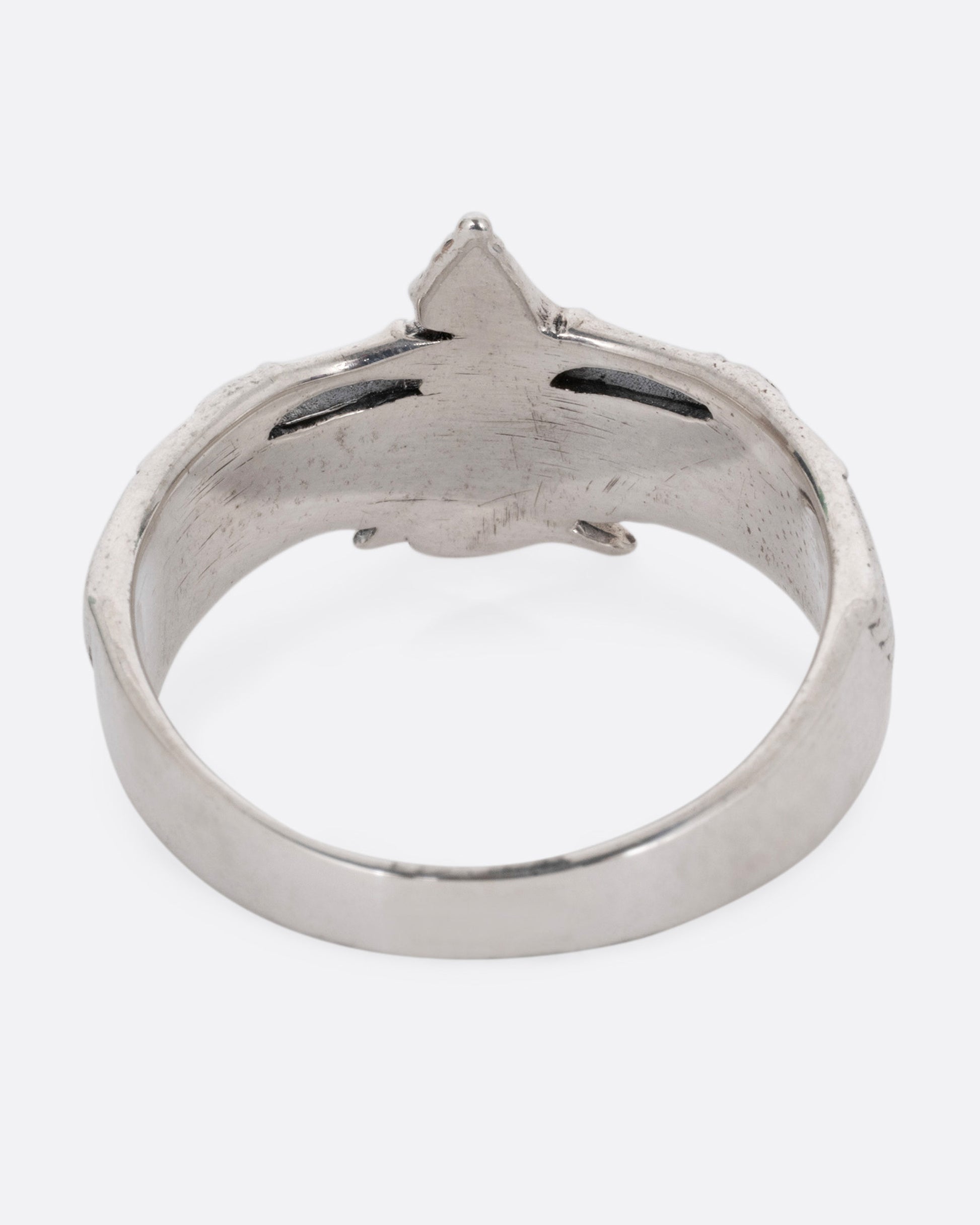 A silver ring with Isis, the ancient Egyptian goddess and powerful magician spreading her wings. Shown from the back.