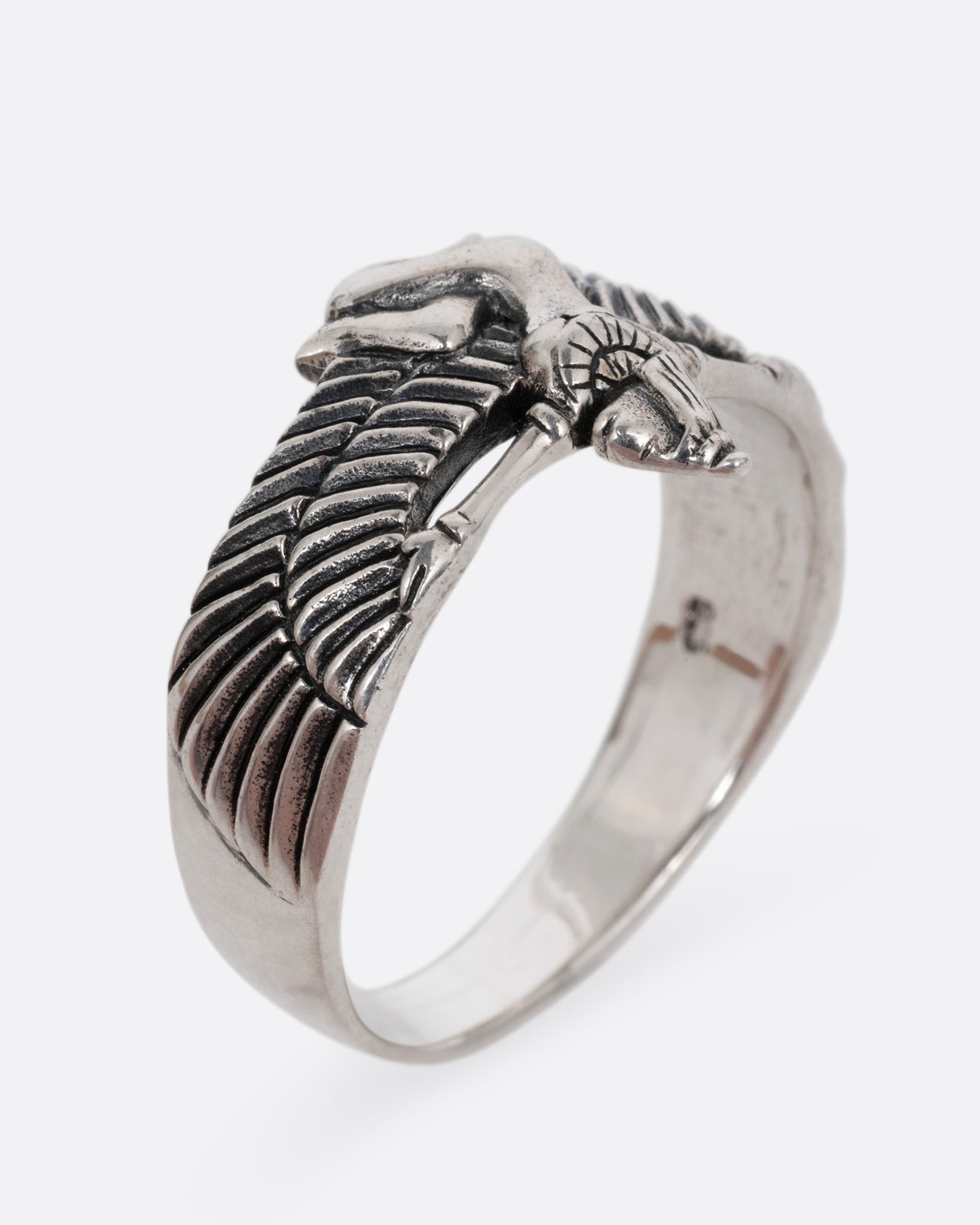 A silver ring with Isis, the ancient Egyptian goddess and powerful magician spreading her wings. Shown from the side standing up.