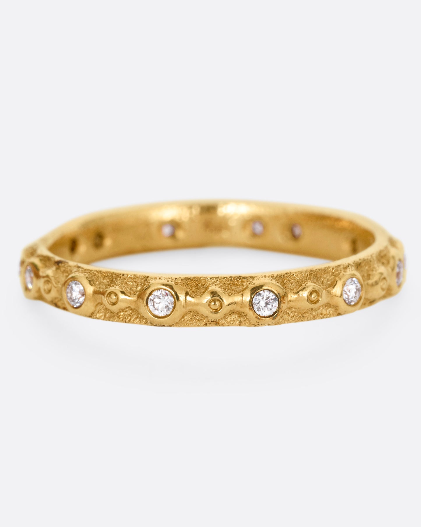 A textured yellow gold ring with white diamonds. Shown from the front.