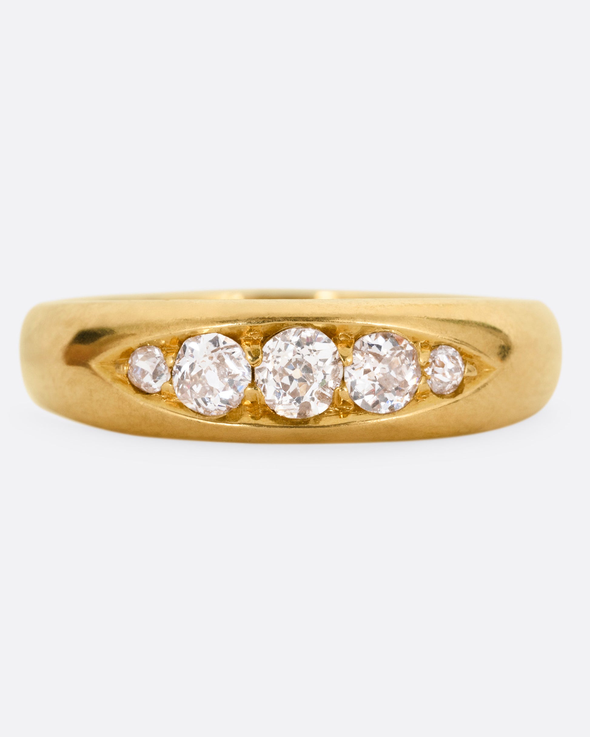 A yellow gold ring with five Old European cut diamonds, shown from the front.