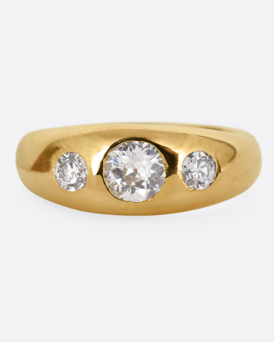A yellow gold ring with three diamonds, shown from the front.