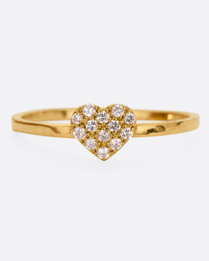 A yellow gold ring with a diamond studded heart. Shown from the front.