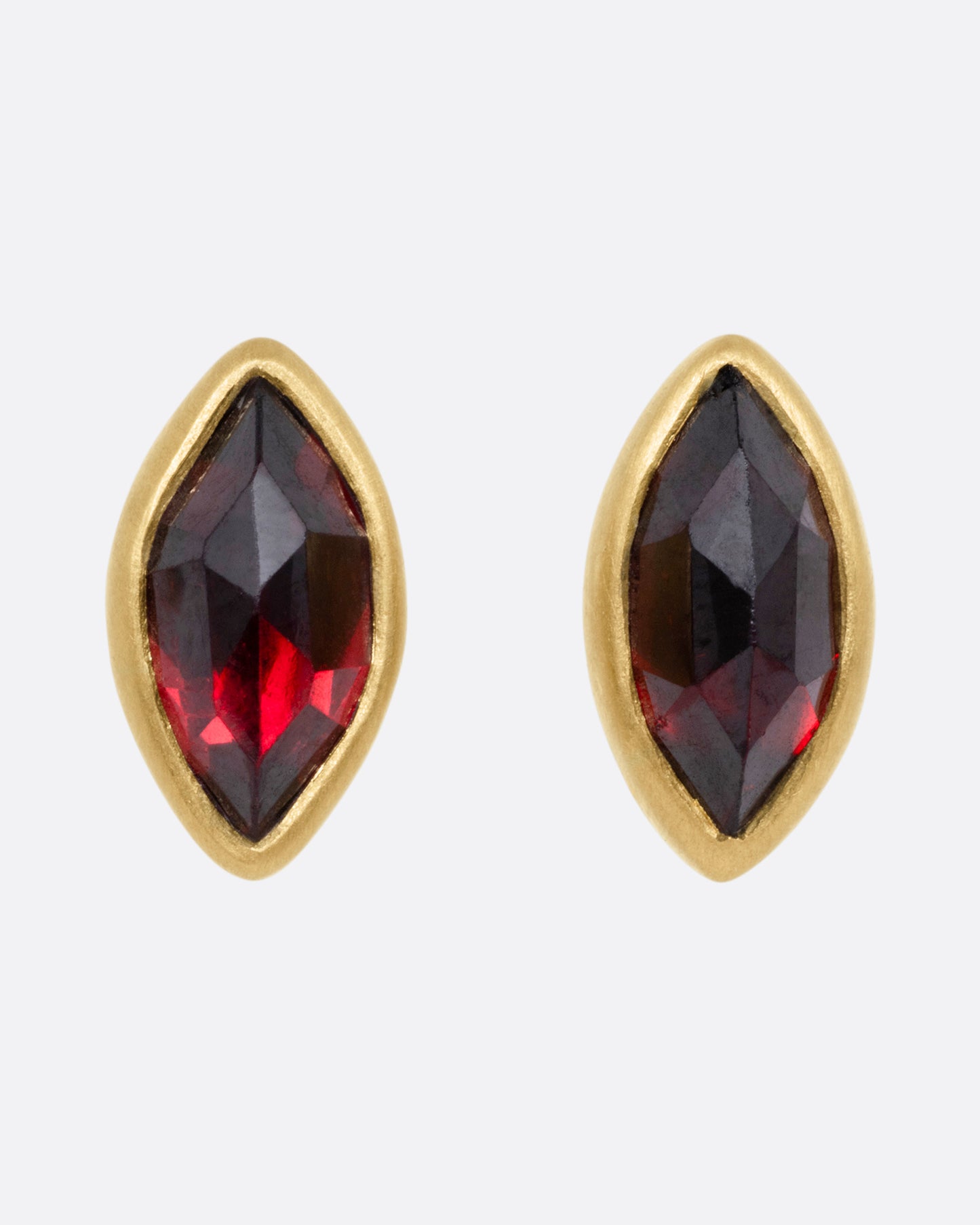 A pair of yellow gold navette garnet earrings, shown from the front.