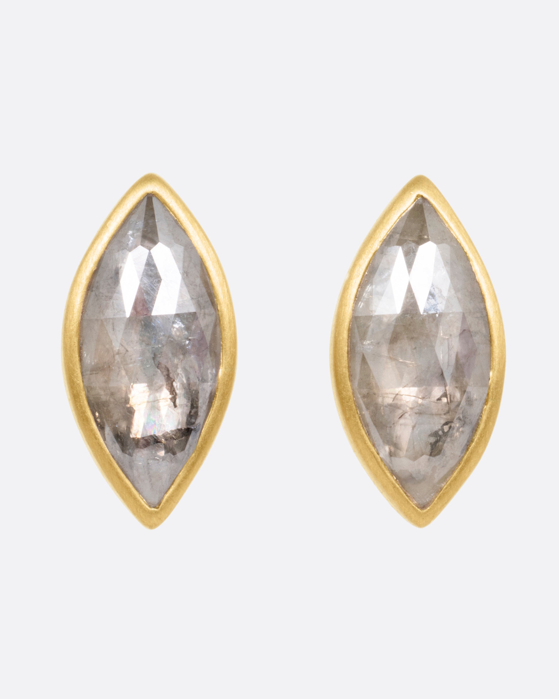 A pair of yellow gold navette diamond earrings, shown from the front.