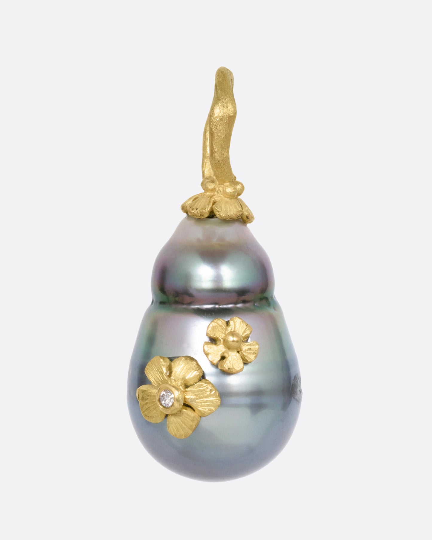 A yellow gold  Tahitian pearl pendant with diamond accented flower details, shown from the front.