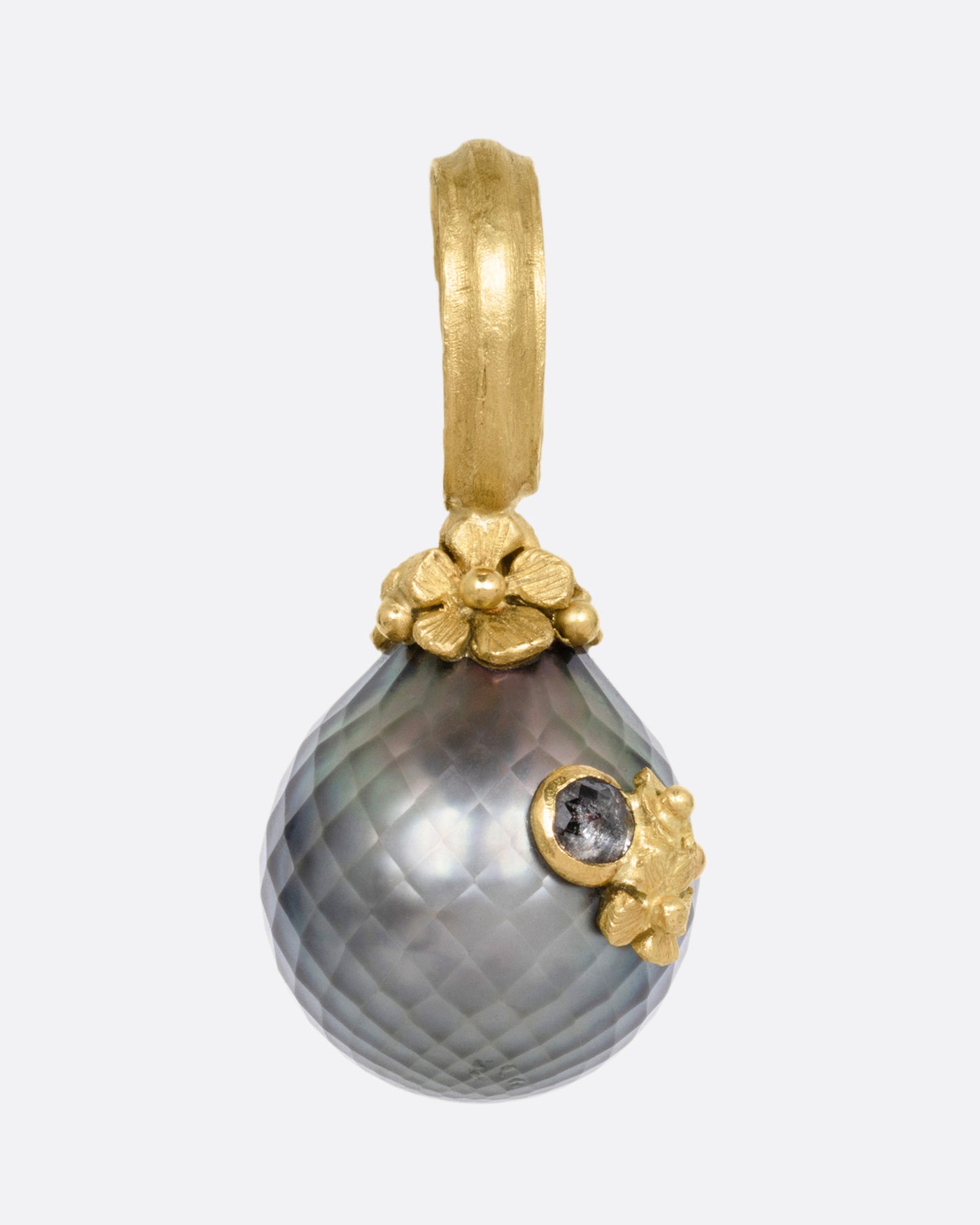 A yellow gold textured Tahitian pearl pendant with diamond accented flowers. Shown from the front.