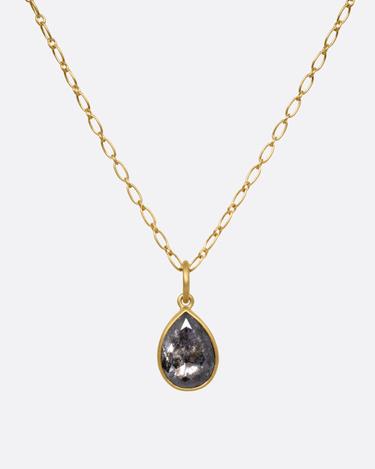 A yellow gold elongated link cable chain necklace with a teardrop shaped salt and pepper diamond, shown from the front.