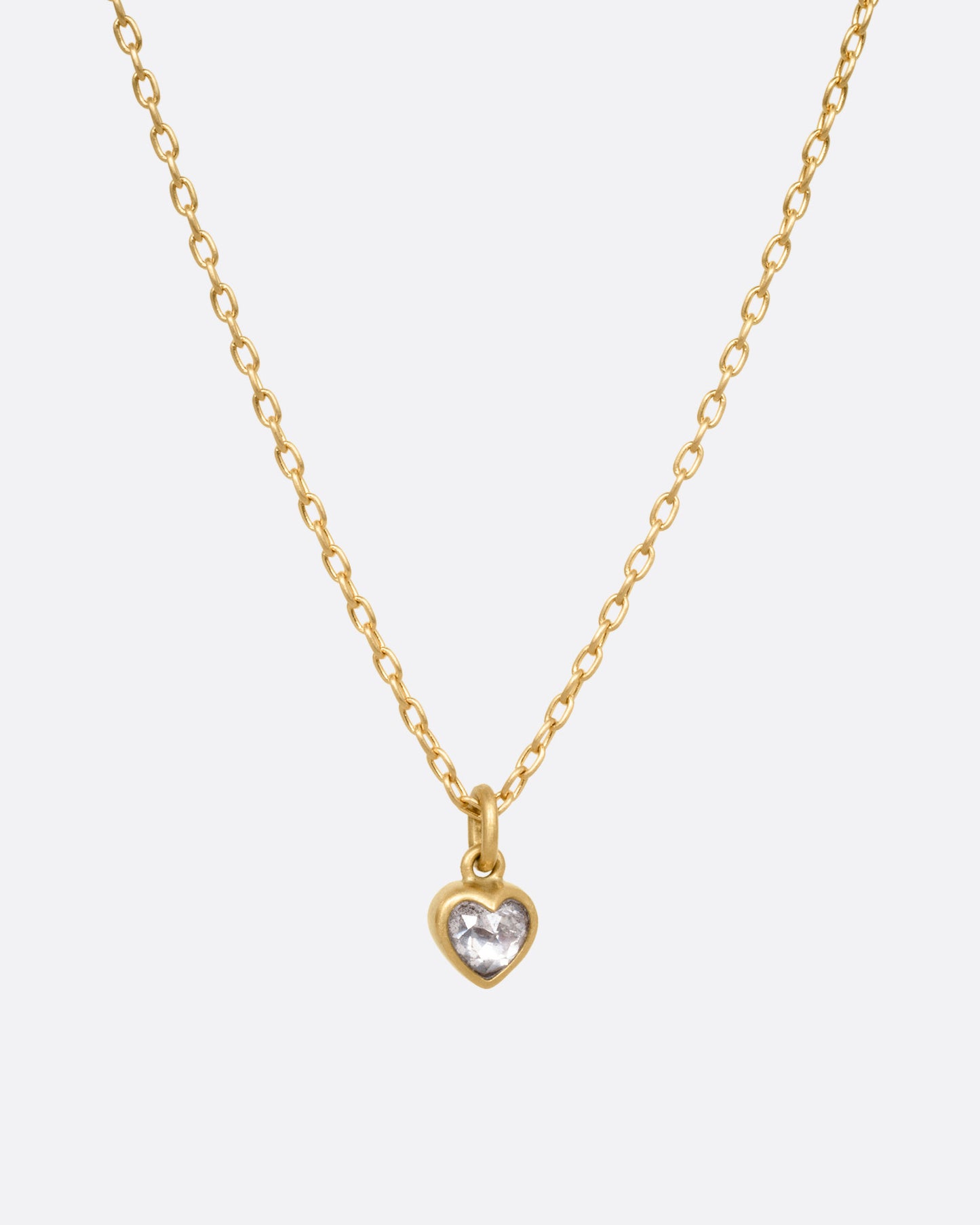 A yellow gold cable chain necklace with a dimensional diamond heart pendant, shown from the front.