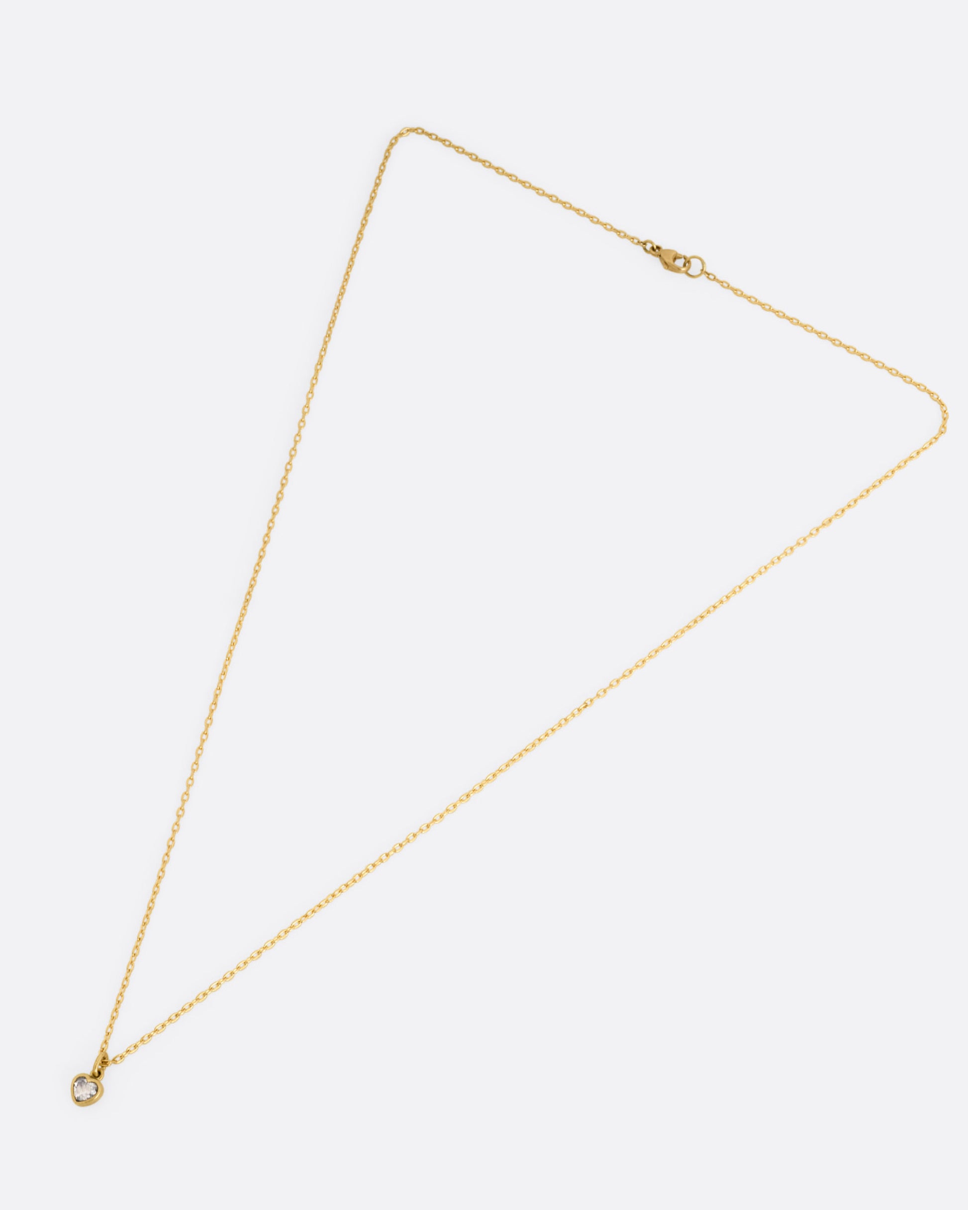 A yellow gold cable chain necklace with a dimensional diamond heart pendant, shown from the front.