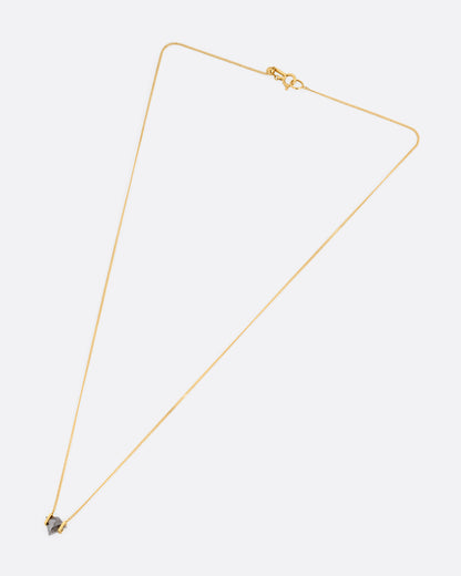 A yellow gold necklace with a salt and pepper diamond pendant, shown from the front.