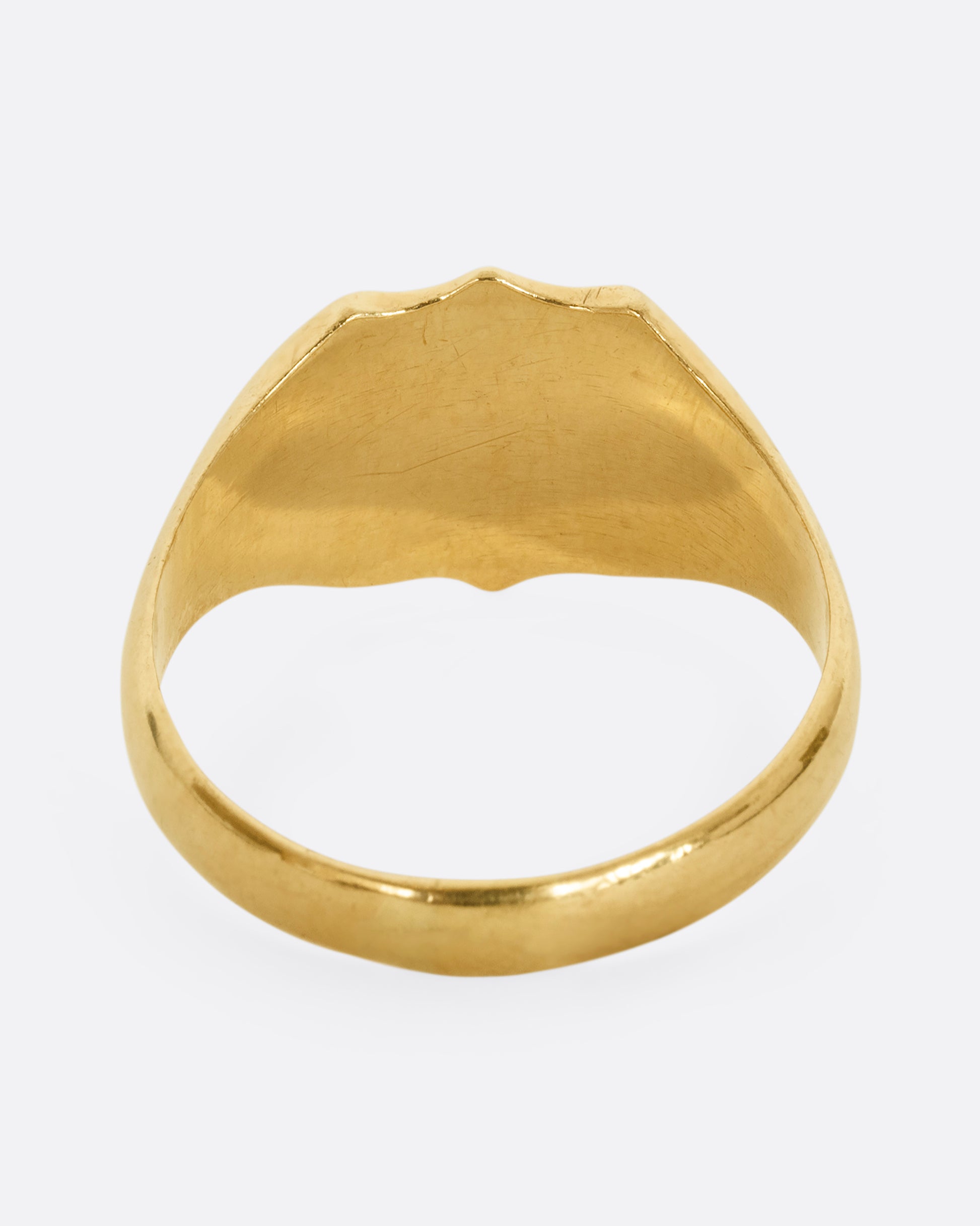 A yellow gold shield signet ring. Shown from the back.