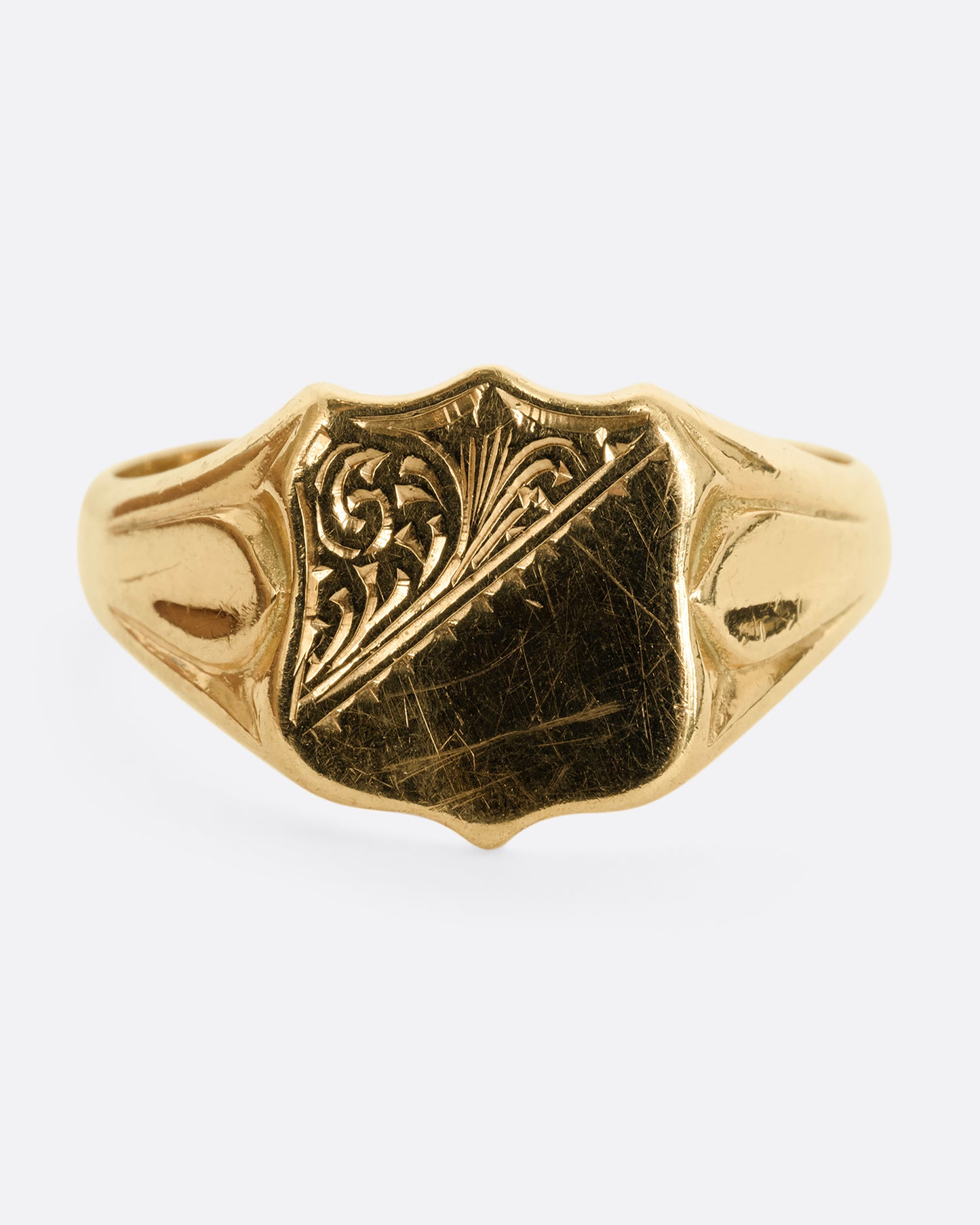 A yellow gold shield signet ring. Shown from the front.