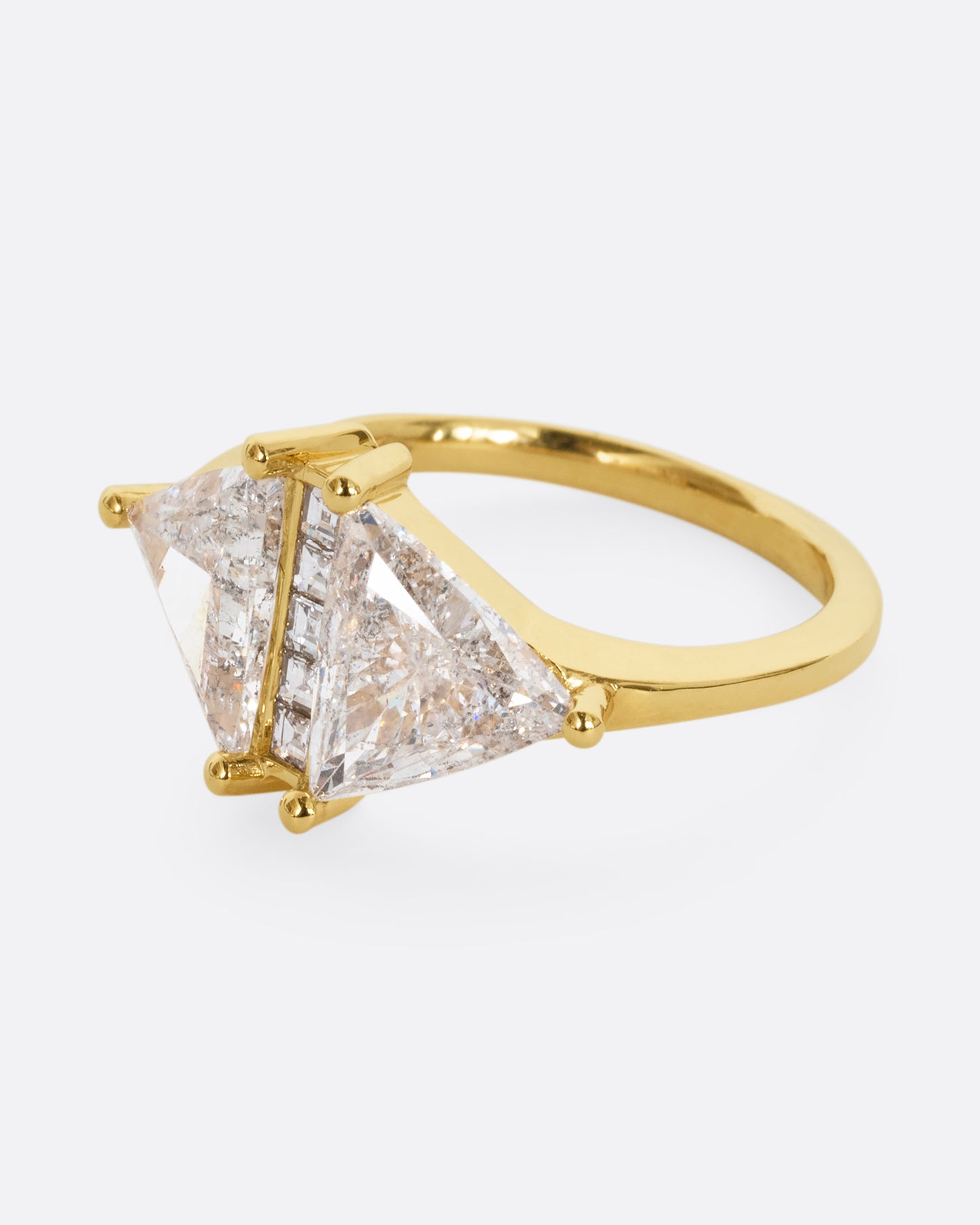 A yellow gold ring with two salt and pepper trillion cut diamonds and diamond accents. Shown from the alternate side.