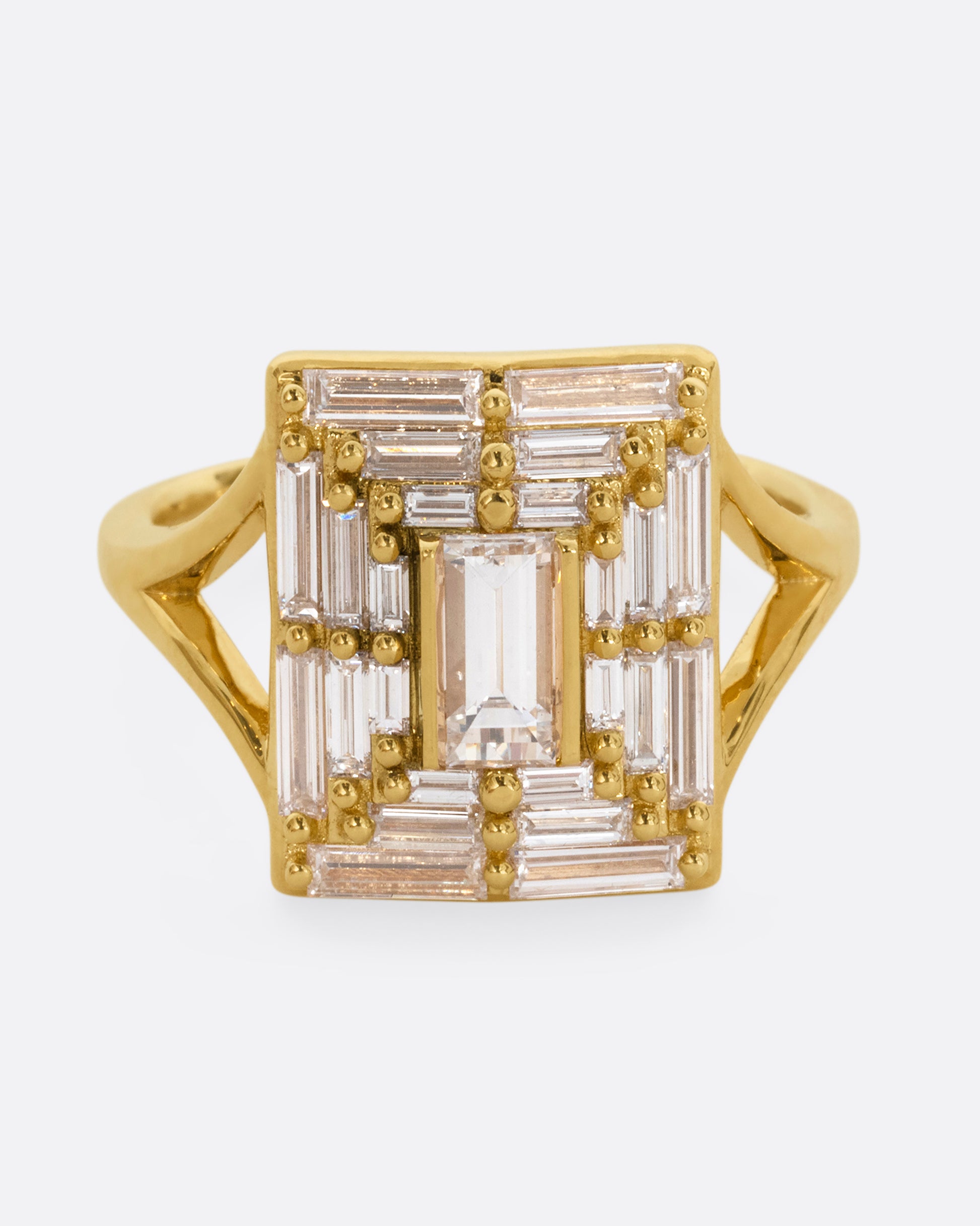 A yellow gold ring with a mosaic of white diamonds in the shape of a square. Shown from the front.