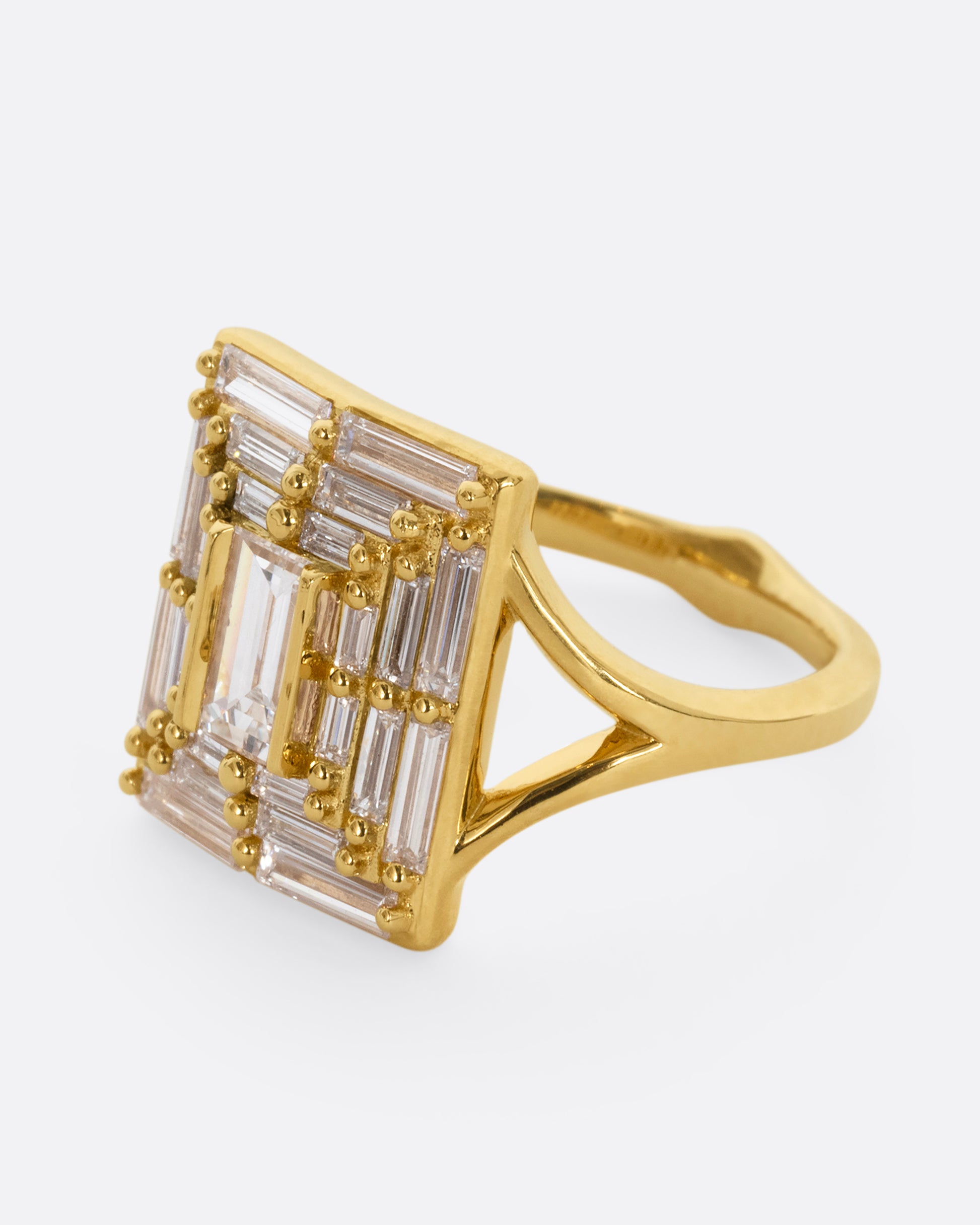 A yellow gold ring with a mosaic of white diamonds in the shape of a square. Shown from the side.