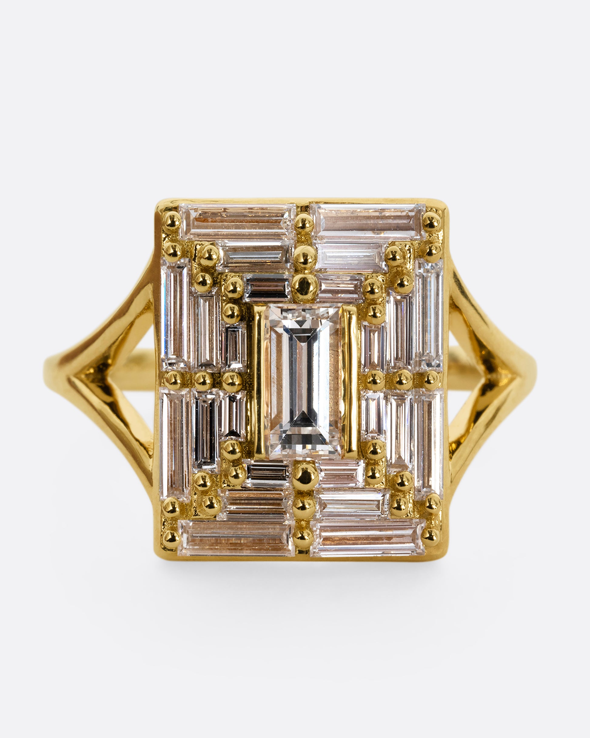 A yellow gold ring with a mosaic of white diamonds in the shape of a square. Shown from the front, close up.