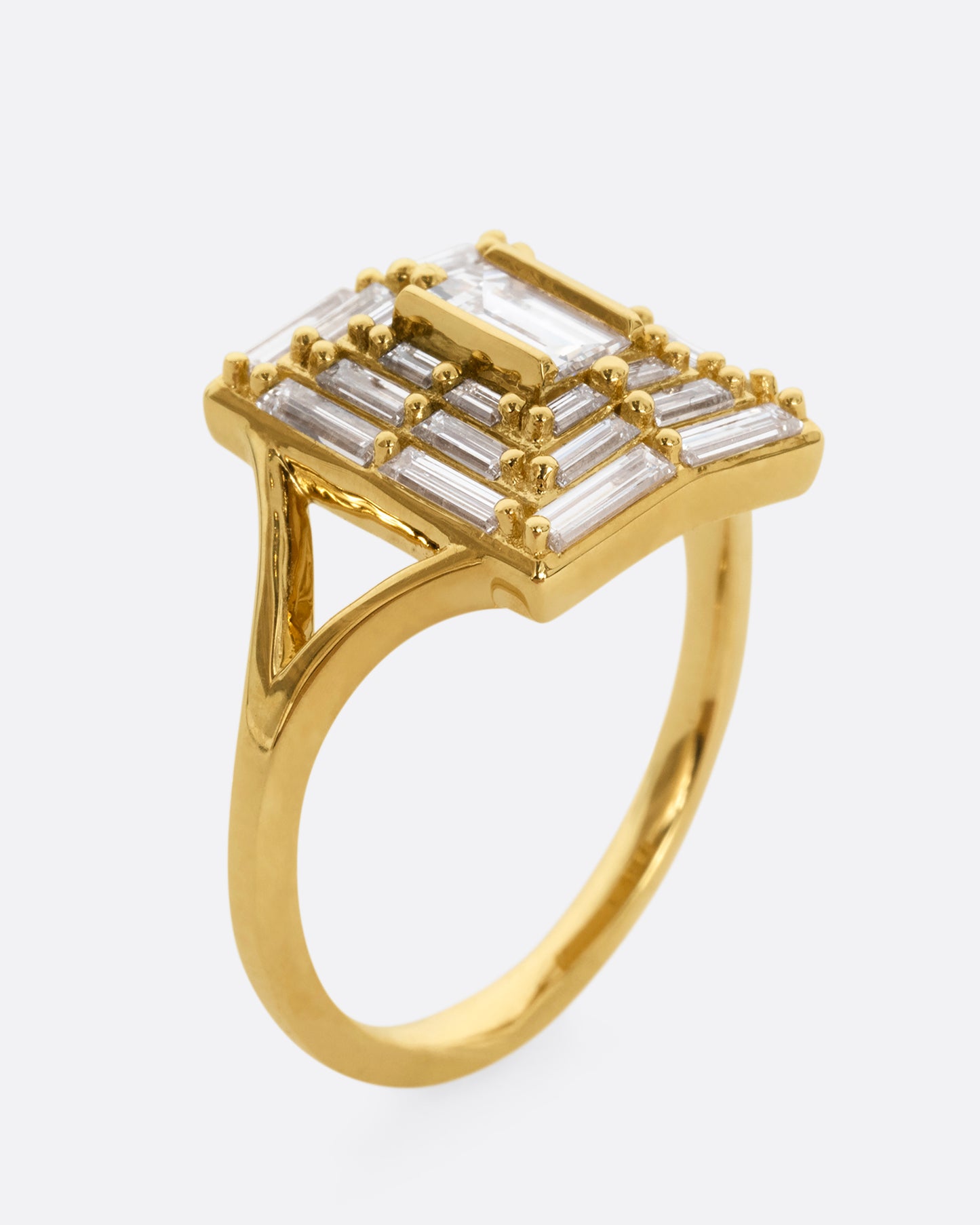 A yellow gold ring with a mosaic of white diamonds in the shape of a square. Shown from the side, standing up.