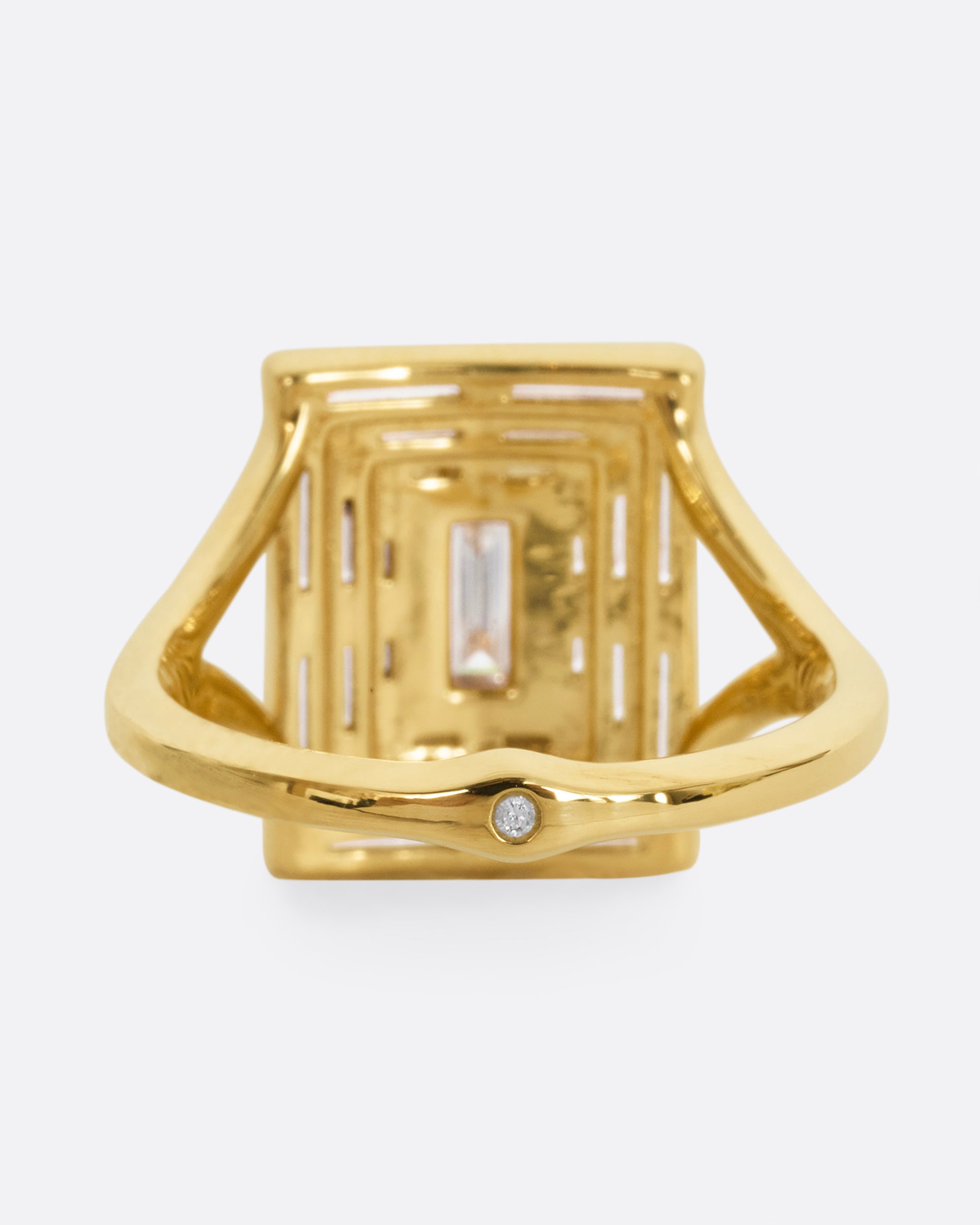 A yellow gold ring with a mosaic of white diamonds in the shape of a square. Shown from the back.