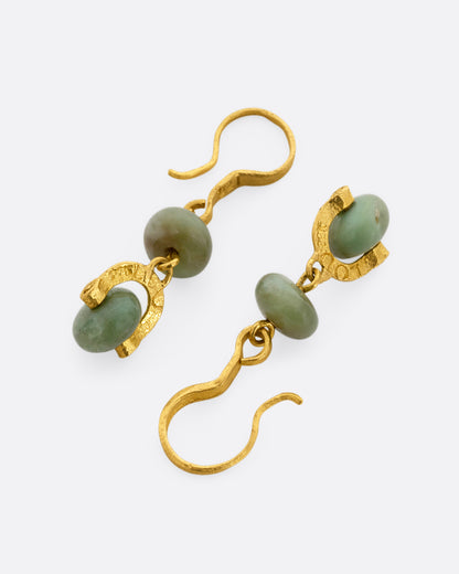 Yellow gold jade stirrup drop earrings, the pair laid flat