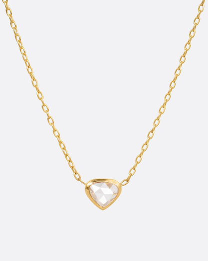 A yellow gold necklace with a natural organic heart shaped diamond, shown from the front.