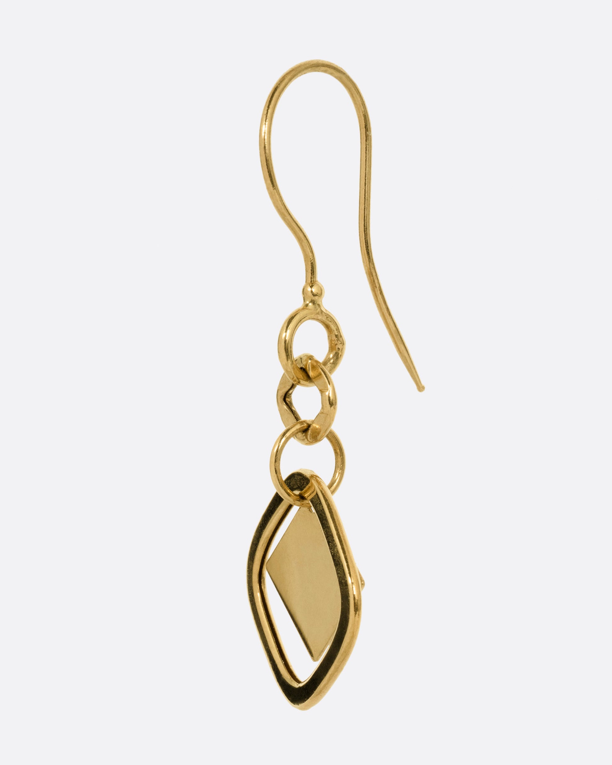 A yellow gold drop earring with a diamond shaped dangle, shown from the side.
