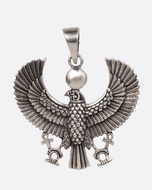 A silver pendant depicting the ancient Egyptian god, Horus, in falcon form, shown from the front. 