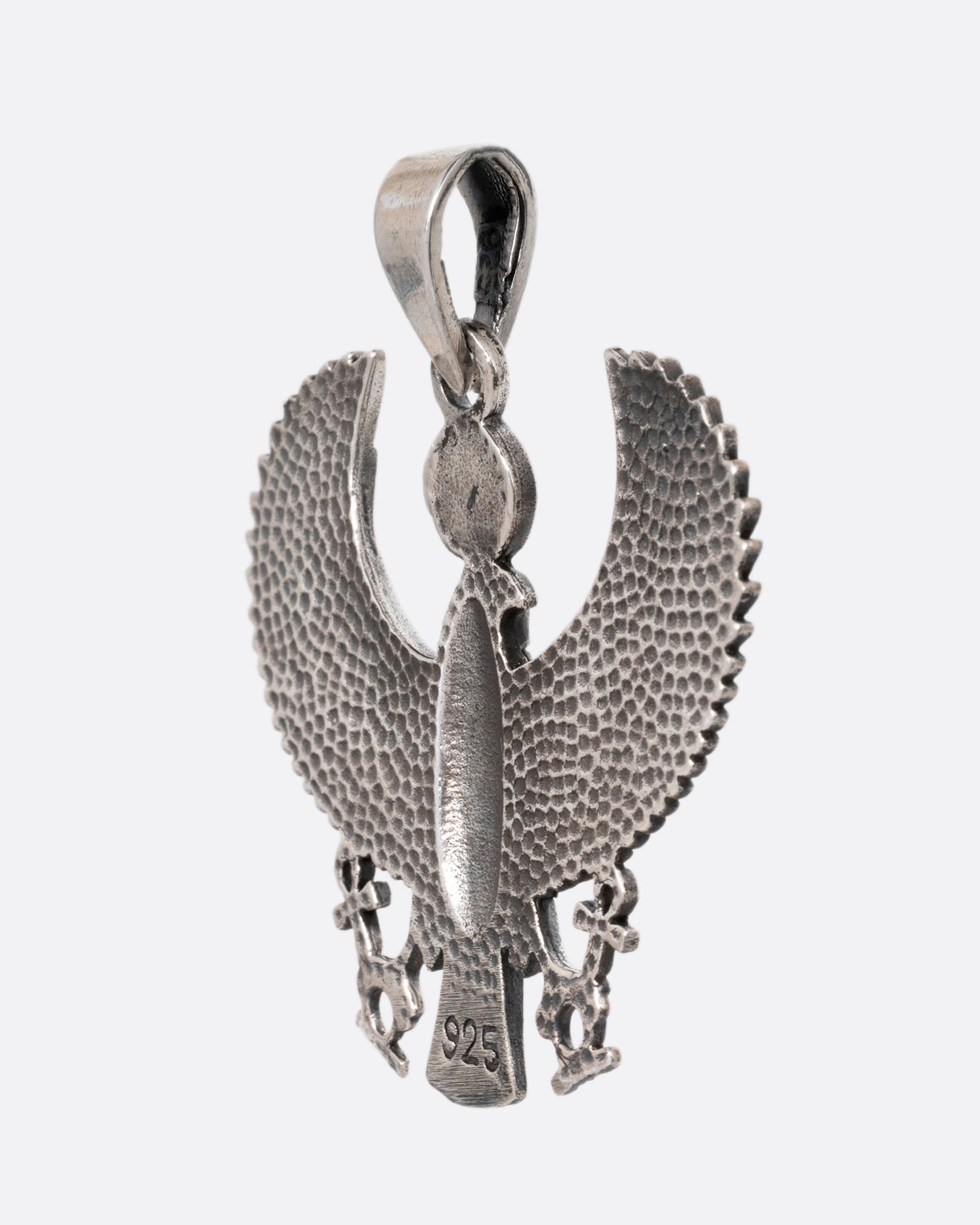 A silver pendant depicting the ancient Egyptian god, Horus, in falcon form, shown from the back. 