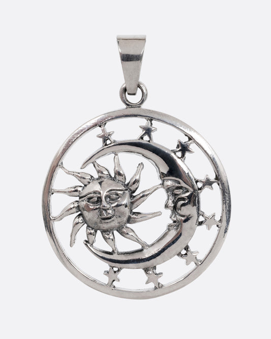 A circular silver pendant with the sun, moon, and stars, shown from the front.