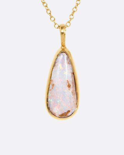 A yellow gold cable chain necklace with a teardrop shaped Australian opal pendant. Shown from the front.