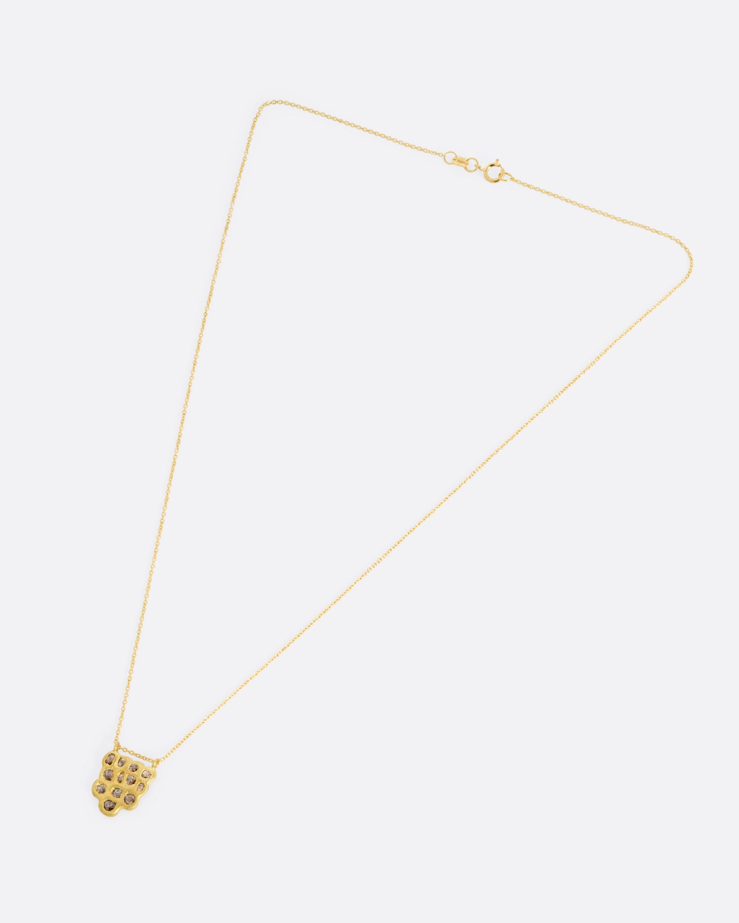 A yellow gold pendant necklace with a cluster of rose cut diamonds, shown from the front.
