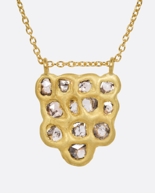 A yellow gold pendant necklace with a cluster of rose cut diamonds, shown from the front.