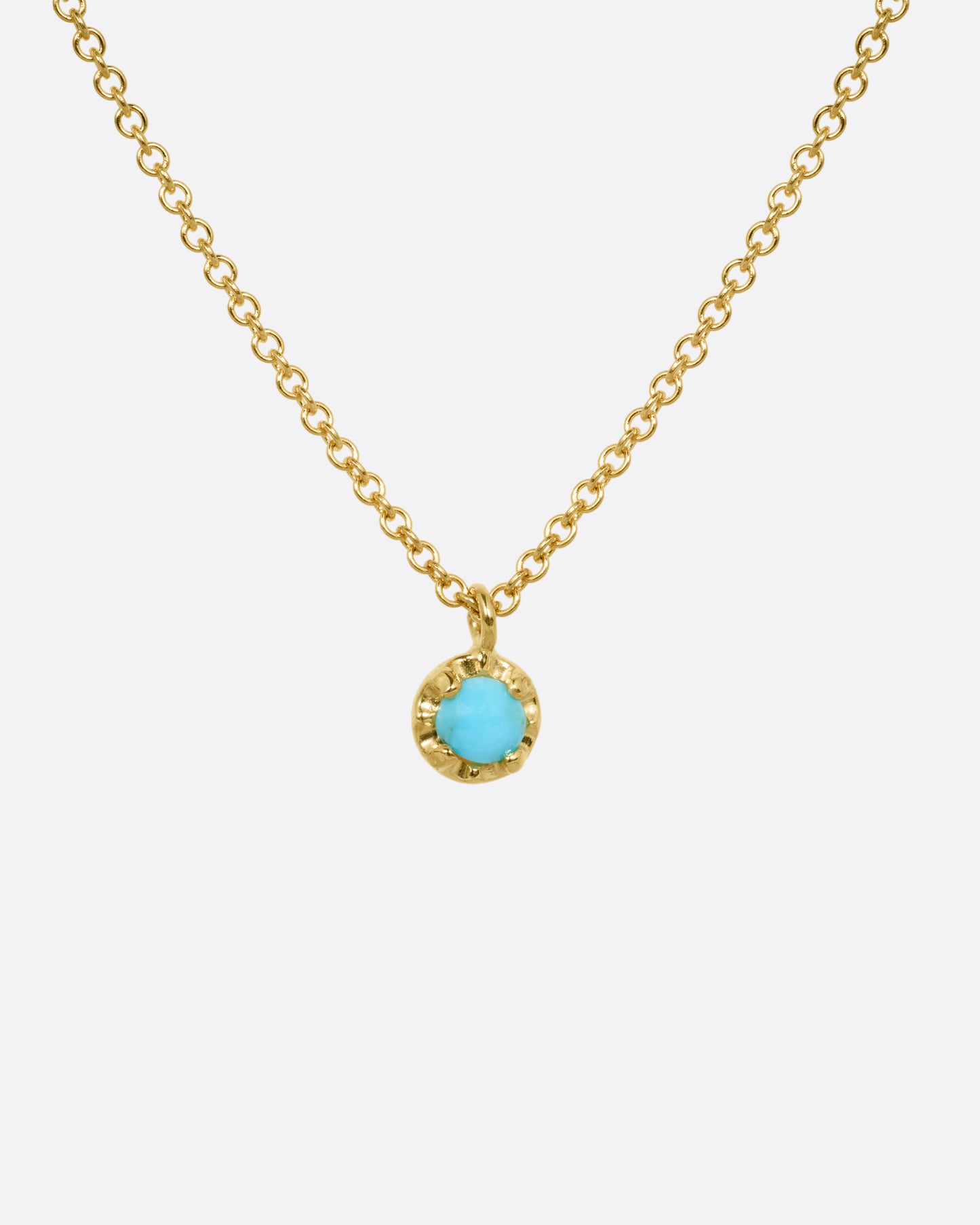 A yellow gold cable chain necklace with a  prong set turquoise, shown from the front.