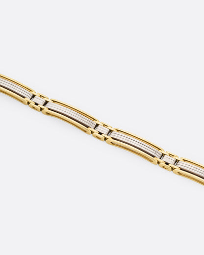 A yellow and white gold link bracelet, shown from the front.