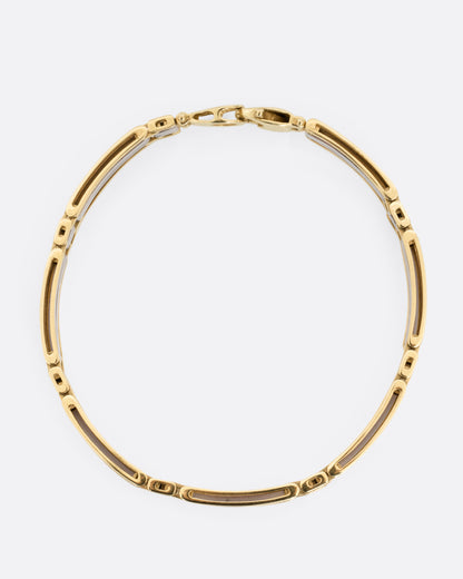 A yellow and white gold link bracelet, shown from the top.